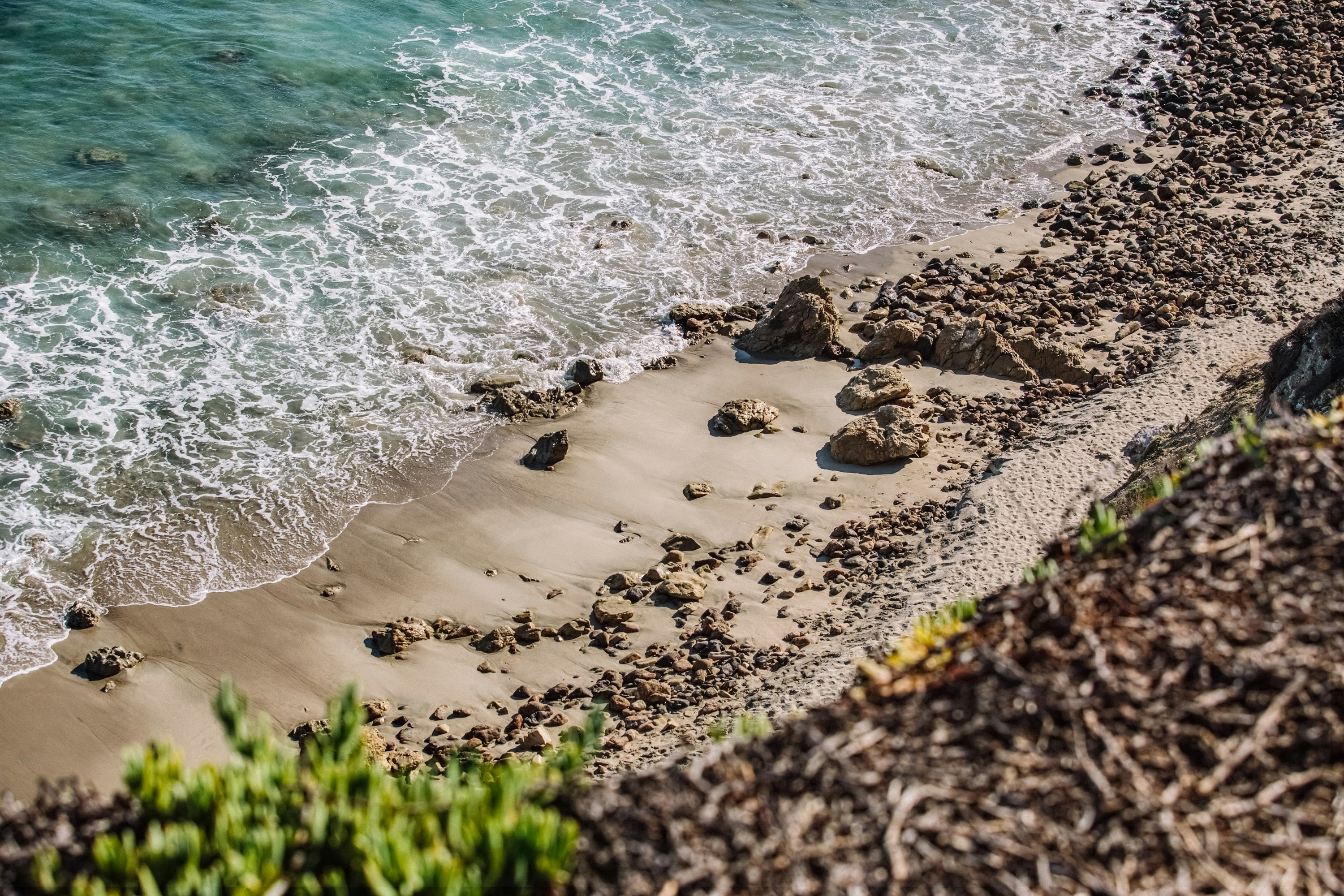 aerial photography of waves splashing on seashore